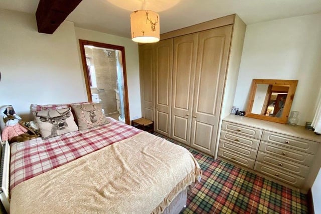 This second double cottage bedroom has plenty of floor space, with wardrobes and storage.