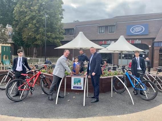 Photograph: The photo shows Cllr Steve Bowles (Aylesbury Garden Town Board Chairman), John Watson (Hale Leys Centre Manager) and Frank Bennet (Bennet Construction) behind, with students from St Michaels School making use of the cycle park.