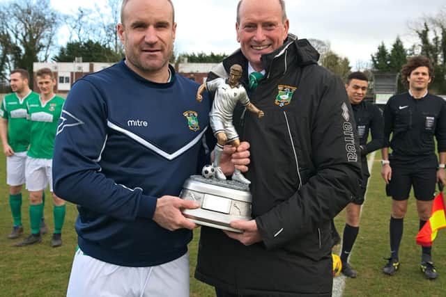 Chairman Graham Read presents Greg Williams with a trophy to recognise his 500th appearance for the club