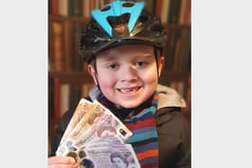 Isaac with his fundraising money so far!
