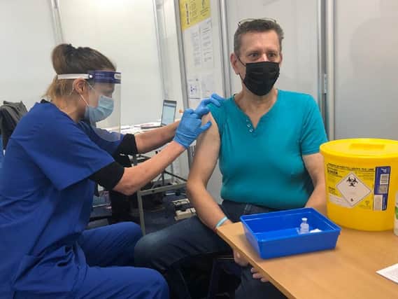 Pictured: Vaccinator Sarah Hyde gives a jab to David Bowen, a clinically extremely vulnerable patient, and one of the first to visit the new Large Scale Vaccination site at Buckinghamshire New University's Aylesbury campus this week.