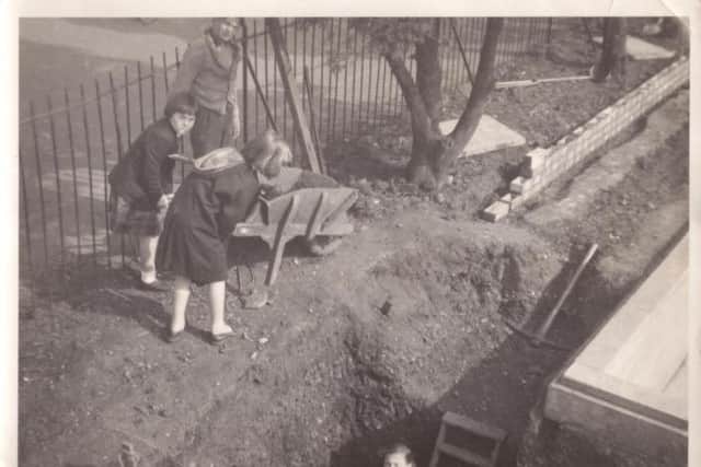 Everyone chipping in for the pool dig in 1957