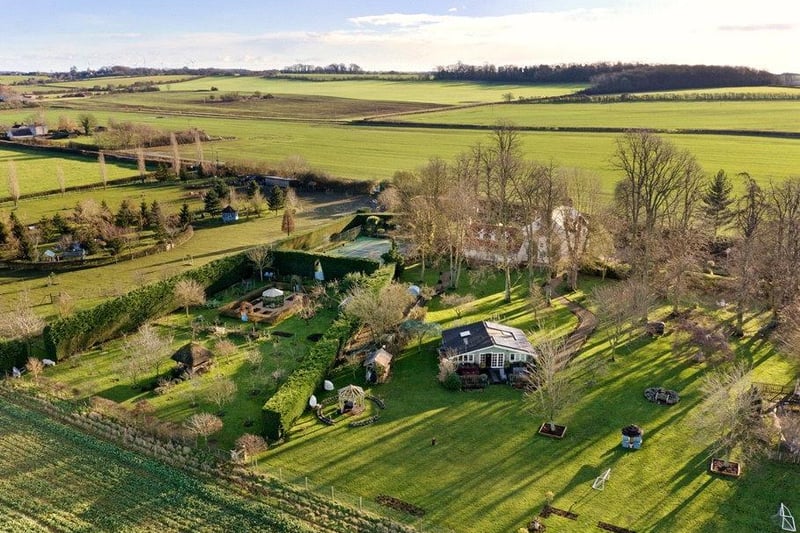 This birdseye look at the home underlines the sheer scale of the area that comes with the property. Not only can you see the massive five-bedroom home, but also the tennis court, separate apartment and luxurious lawns.