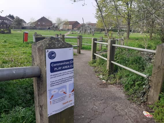 A play area in Meadowcroft with a covid-19 warning sign