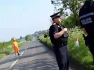 HS2 worker standing in the road watching police talk to protesters (4 May)