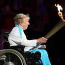 Margaret Maughan lighting the Olympic flame in 2012