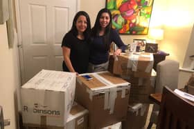 Iliana and Deyali preparing boxes to send over to children in need