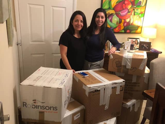 Iliana and Deyali preparing boxes to send over to children in need