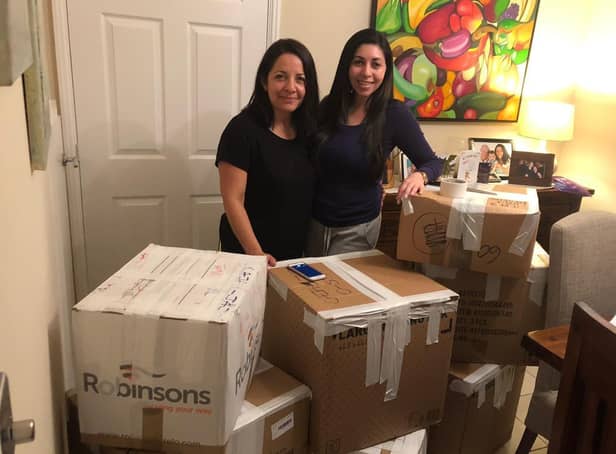Iliana and Deyali preparing boxes to send over to children in need