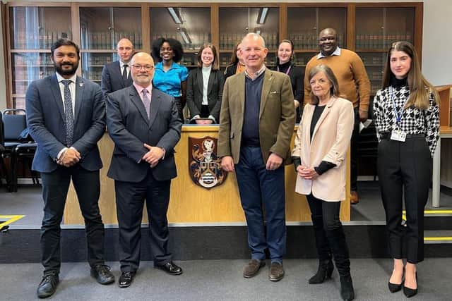 High Sheriff of Bucks George Anson, centre right, in the University of Buckingham's Law School with Dean of Computing, Psychology and Law Prof Harin Sellahewa and law lecturers in the front row, with law students and staff in the back row.