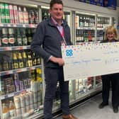 An Aylesbury Vineyard Storehouse spokesperson collecting the big cheque
