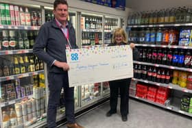 An Aylesbury Vineyard Storehouse spokesperson collecting the big cheque