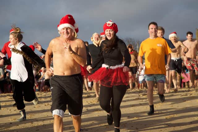 Swimmers race for the North Sea on Christmas Day