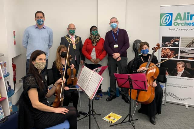 Mayor of Aylesbury Anders Christensen with members of the Alina Orchestra, communities officer Benedicta Lasoye and library manager Mick Harris
