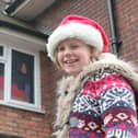 Caroline, smiling in front of 24 advent displays