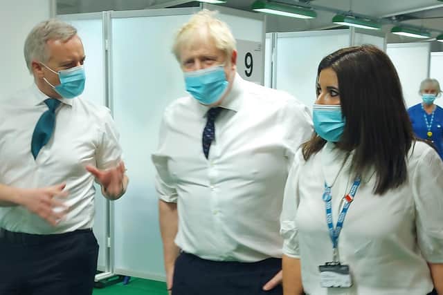Aylesbury MP Rob Butler (left) welcomes PM Boris Johnson to the town's mass Covid vaccination centre in Stoke Mandeville