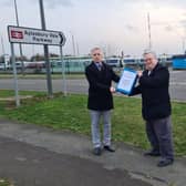 Councillor Mark Winn hands the petition to Rob Butler MP
