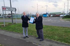 Councillor Mark Winn hands the petition to Rob Butler MP
