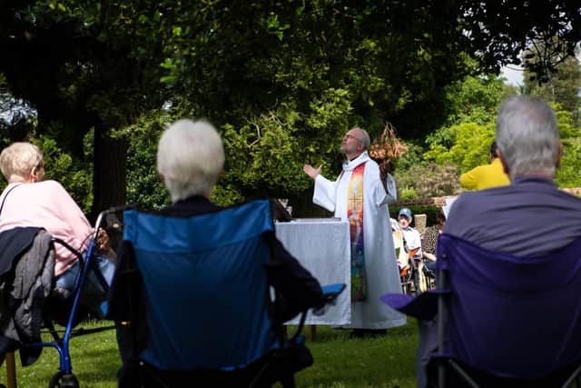 Rev Lightbown conducts an outdoor church service in May 2021