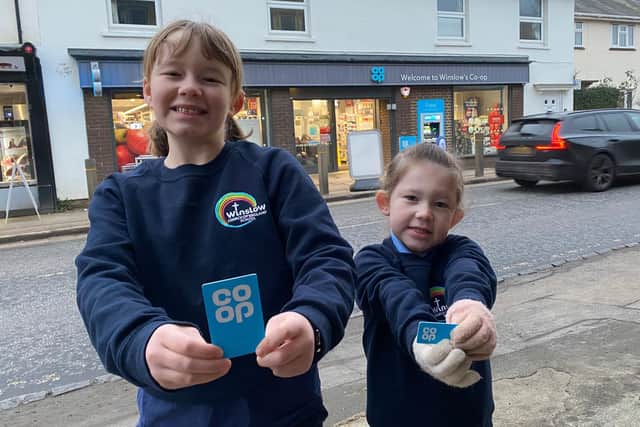 Winslow pupils Lucy and Eloise King with Co-op cards outside the High Street store