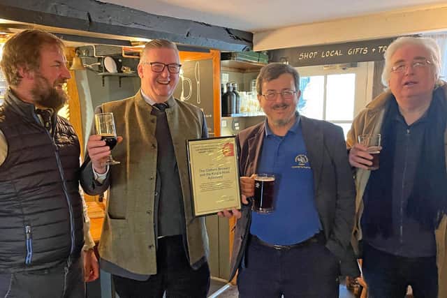 Pictured (left to right): Tom Jenkinson, George Jenkinson, Giles du
Boulay, David Roe (treasurer of the local CAMRA branch) in the Farmers’ Bar at the King’s Head.