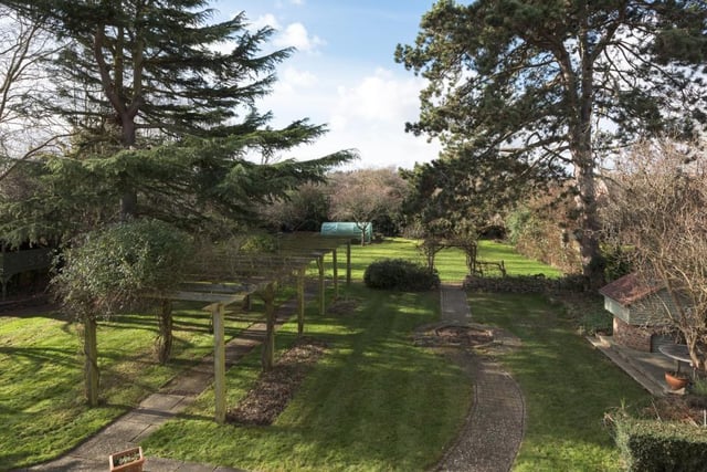 A bespoke timber walkway, bedecked with beautiful roses, leads you to a superb lawn that was once a tennis court, and on to vegetable and fruit areas, where you can pluck apples and mulberries from trees planted by the Laxtons