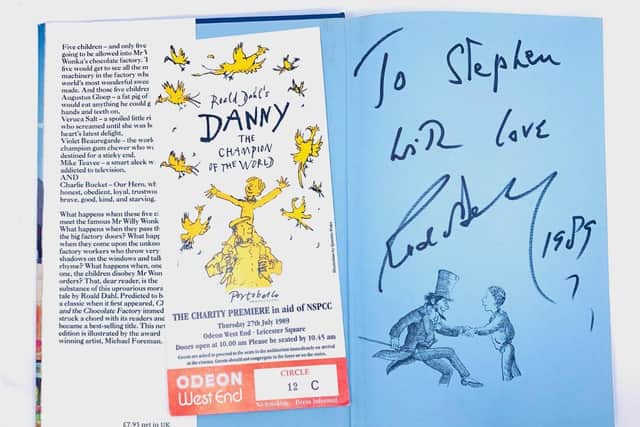 The personally signed book up for grabs and a ticket from the Danny, the Champion of the World, London premiere, photo from Hansons Auctioneers