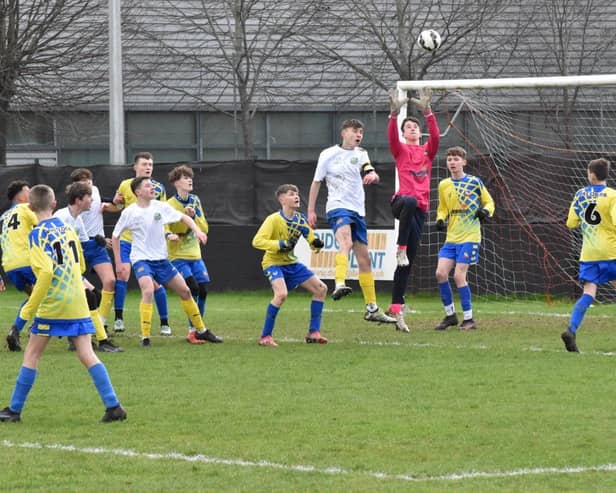 Bobby Swain makes a save the Under 14s cup final