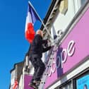 Buckingham Town Council's ground maintenance supervisor Ian Saunders hangs a French flag