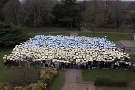 The whole school gathered on the front lawn to form a giant Ukrainian flag