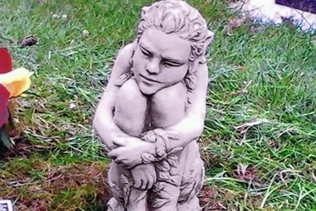 The Celtic statue that has gone missing from Peter Innes' grave