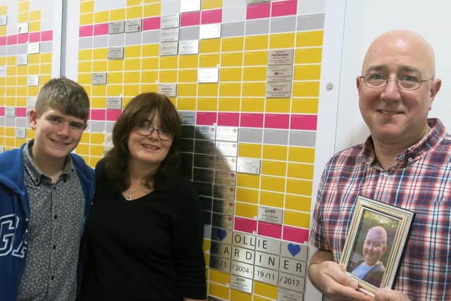 Theo, Jane and Peter Gardiner at Wall of Hope at Queen Mary Univ of London.
