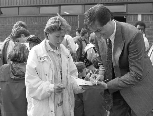 Aylesbury United's Cliff Campbell signing autographs before the game which attracted a record crowd of 6,000 to Buckingham Road