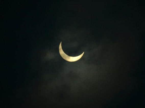 The moon partially covers the sun during an annular solar eclipse in June 2020. (Photo: Diptendu DUTTA / AFP)