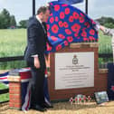 Greg Smith MP unveils the memorial assisted by Lynn Taylor-Overend, daughter of RAF Wing serviceman Eric Taylor,