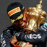 VICTORY: Lewis Hamilton embraces the British Grand Prix trophy after winning at Silverstone on Sunday (Photo Daimler AG)