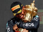 VICTORY: Lewis Hamilton embraces the British Grand Prix trophy after winning at Silverstone on Sunday (Photo Daimler AG)
