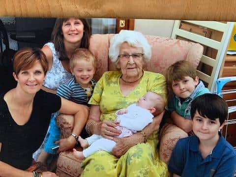 Freda with two granddaughters and her great-grandchildren