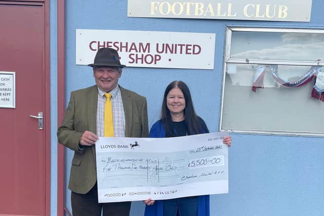 Chesham United chairman Peter Brown hands over the cheque for Bucks Mind