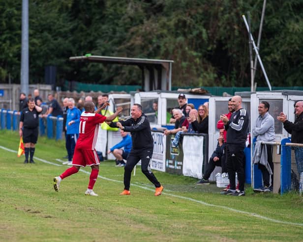 Risborough Rangers' Sam Pekun, scorer of their second goal, celebrating with Manager Mark Eaton (Picture by Charlie Carter)