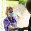A Rennie Grove nurse greets a patient at their home