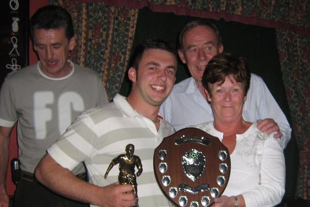PLAYERS' CHOICE...FC Macosquin Players Player of the Year Chris McAfee receives his award during the club's presentation night in the Offshore Bar, Portrush form Mr and Mrs Noel Kennedy, proprietors. Cr19-377s