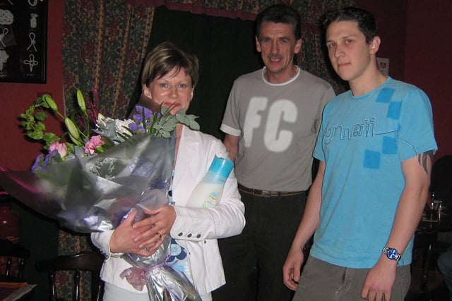 'SAINT JOAN'...FC Macosquin's David Hoey presents Joan McAfee with flowers for her assistance with the club during the season. Included is club chairman Jackie McAfee. Cr19-380s