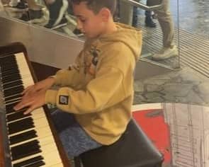 Max playing to the crowds in Euston Station.