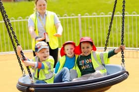 Children from Field House Day Nursery test out a swing