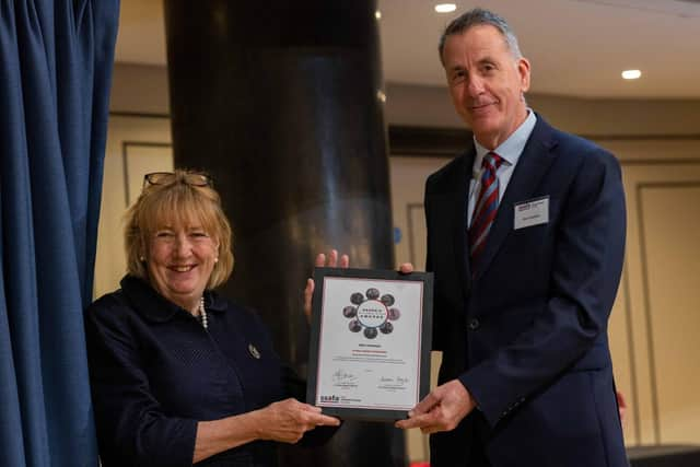 Glyn receiving his award from The Lady Dannatt