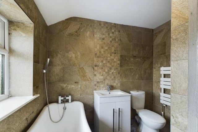 One of four bathrooms in the property, this one contains a cosy bath.