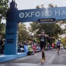 A runner crosses the line in 2024's Oxford Half.
