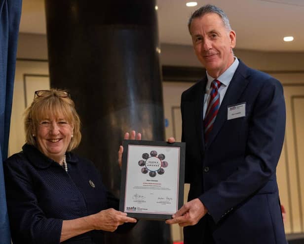 Glyn receiving his award from The Lady Dannatt