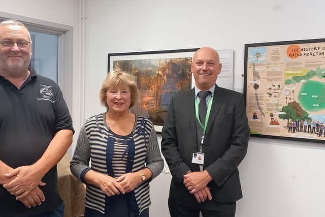 Terry Cavender of Buckingham Canal Society, Lyn Robinson of Maids Moreton Conservation Group and Cllr Gary Hall with the paintings